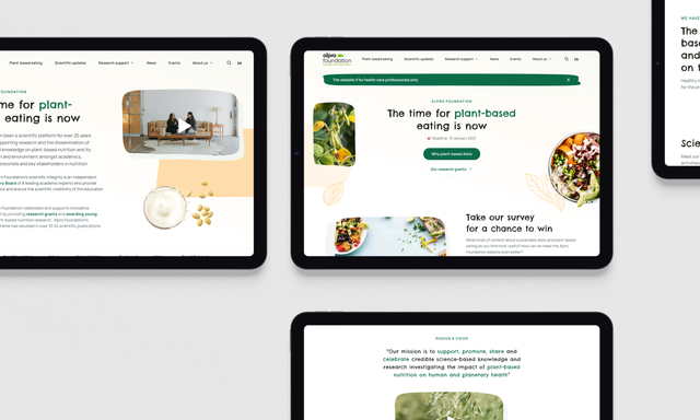 Multiple tablet screens display a modern website design promoting plant-based eating with green accents, food photography, and clean typography.