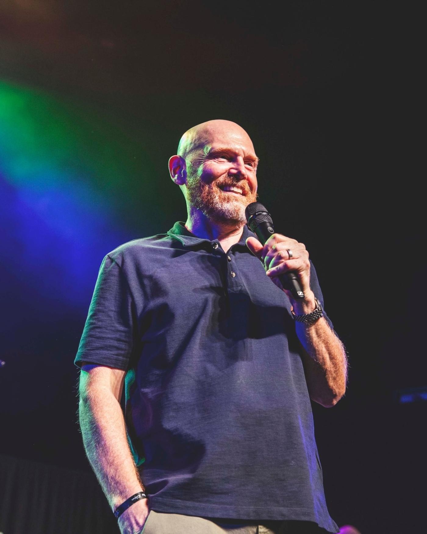 Bill Burr hosting on stage, microphone in hand