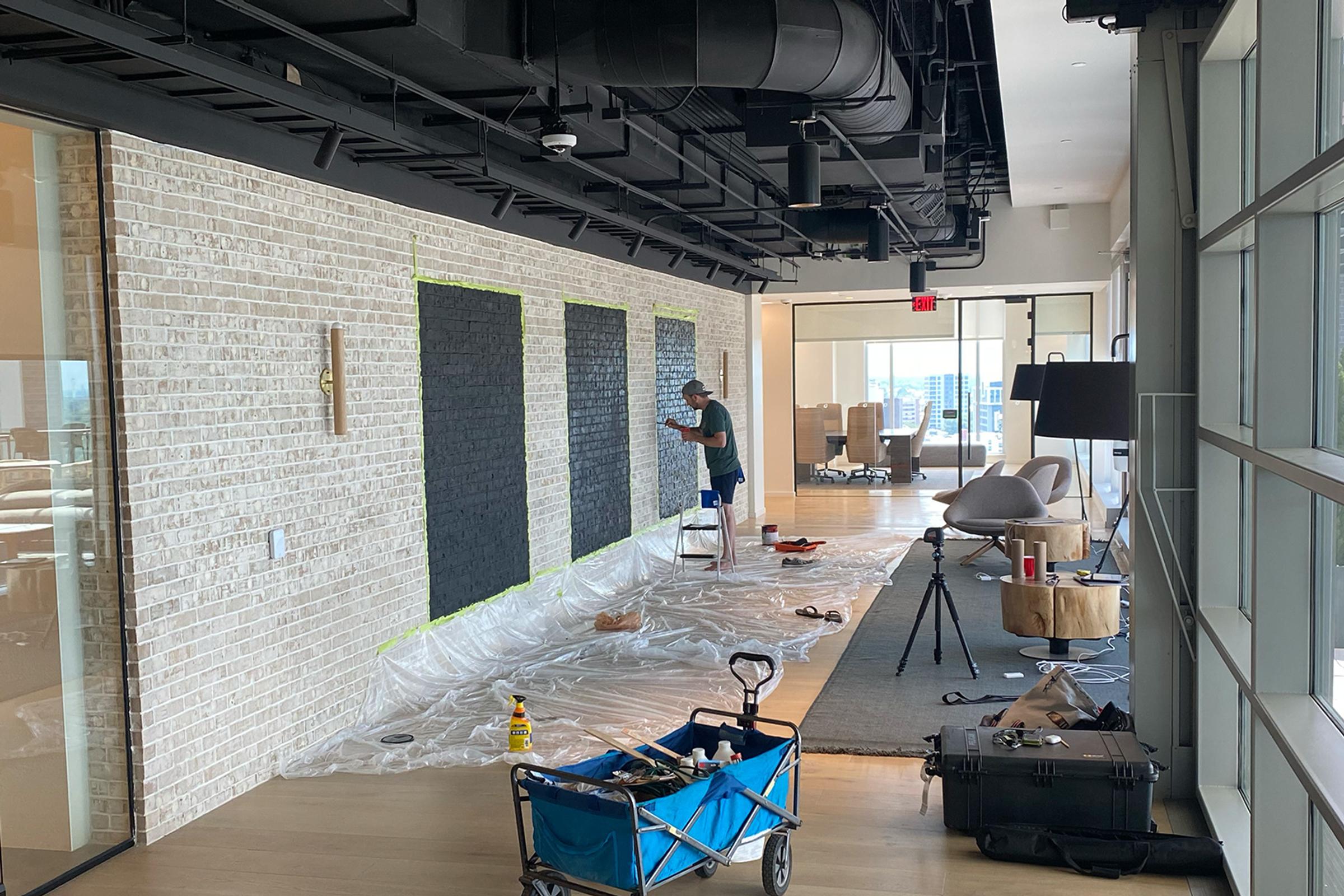 Nate starting the first LendingTree mural along a long office wall