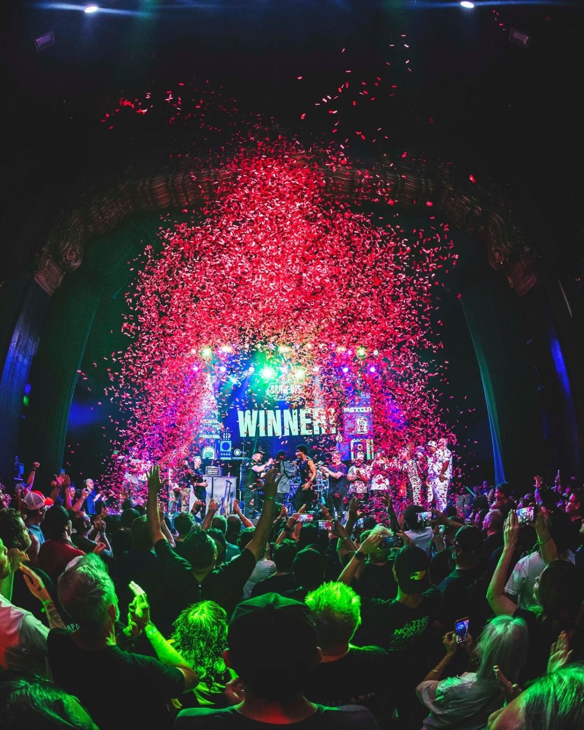 Confetti falling over the crowd and the WINNER! screen at the Drum-Off finals