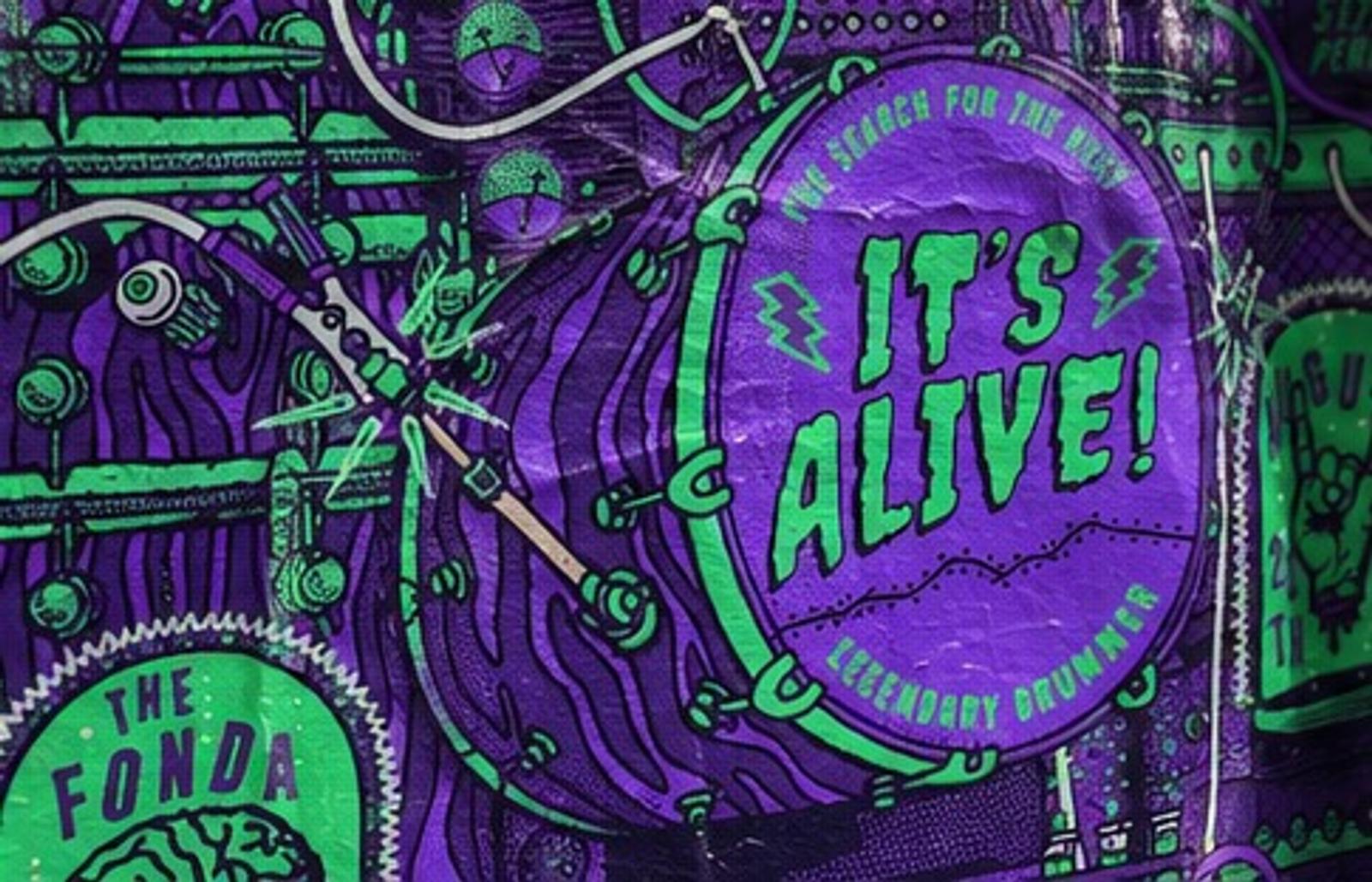 Mockup: close-up of the It's Alive! kick drum on a wheatpasted poster