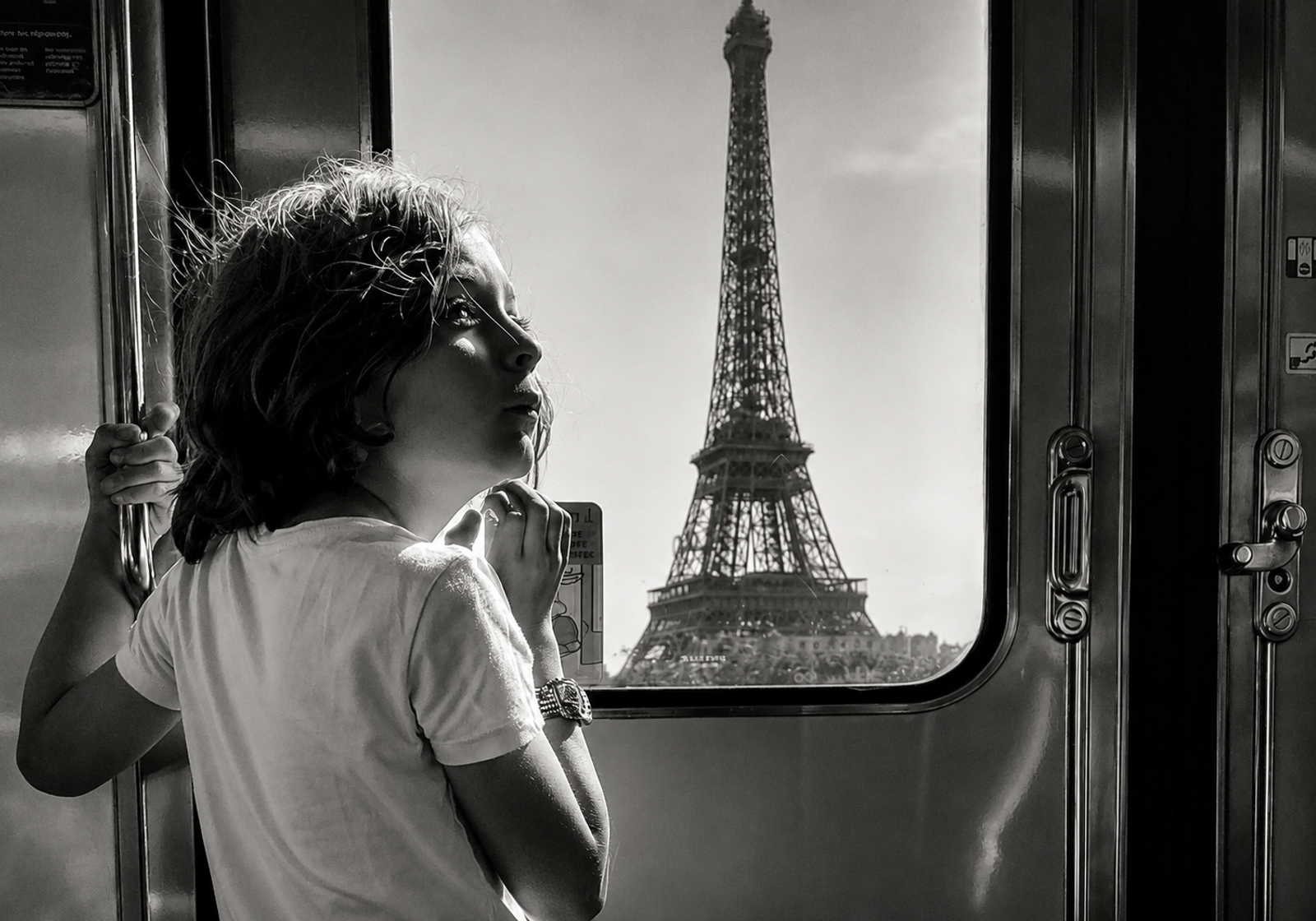 Brody looking out a train window at the Eiffel Tower in Paris