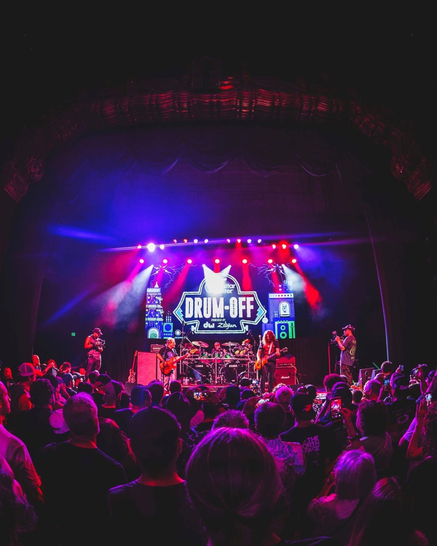 A packed Fonda Theatre facing a stage lit under the Drum-Off logo