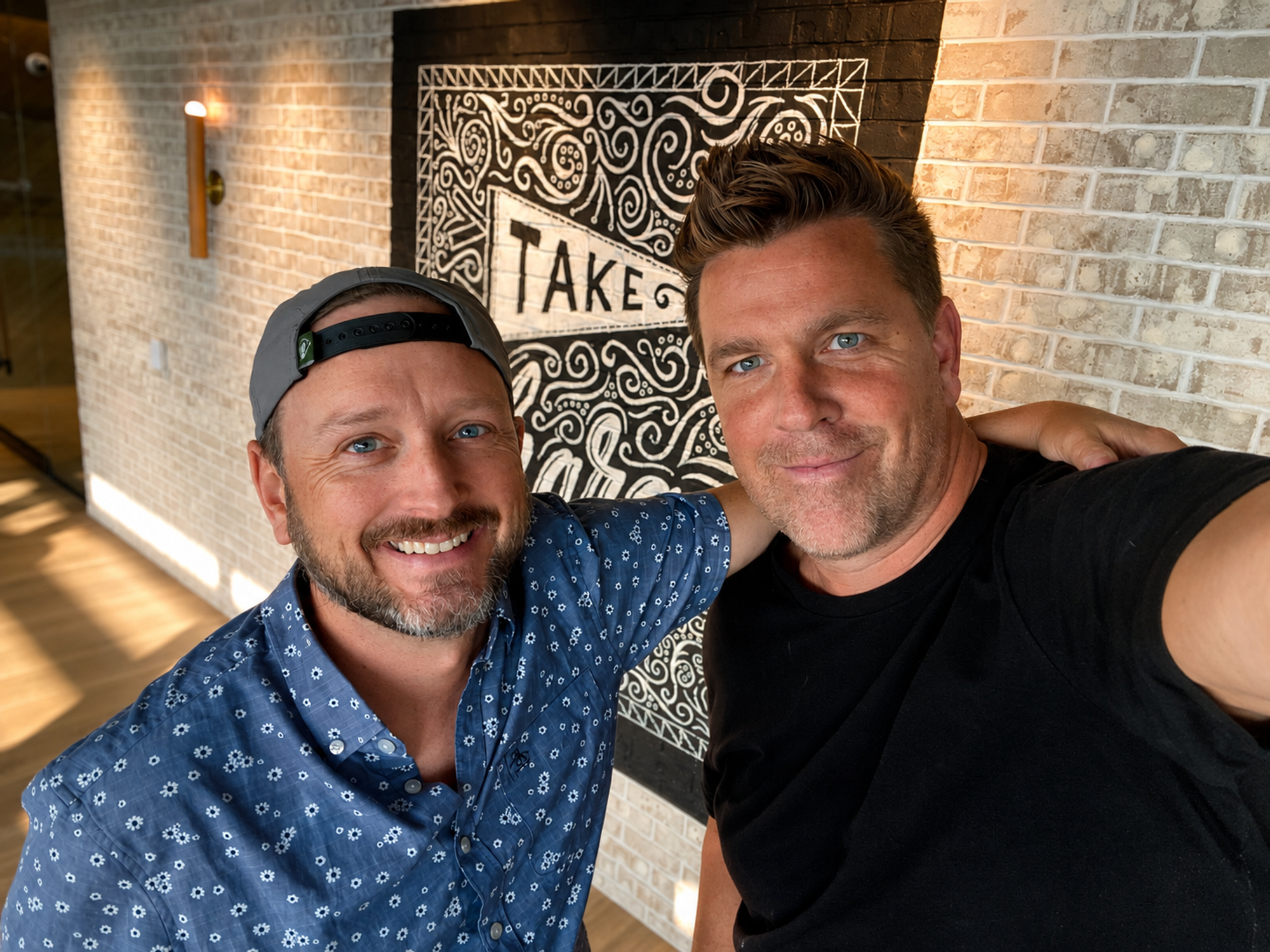 Nate and Todd Lauer in front of the Take Charge mural at LendingTree