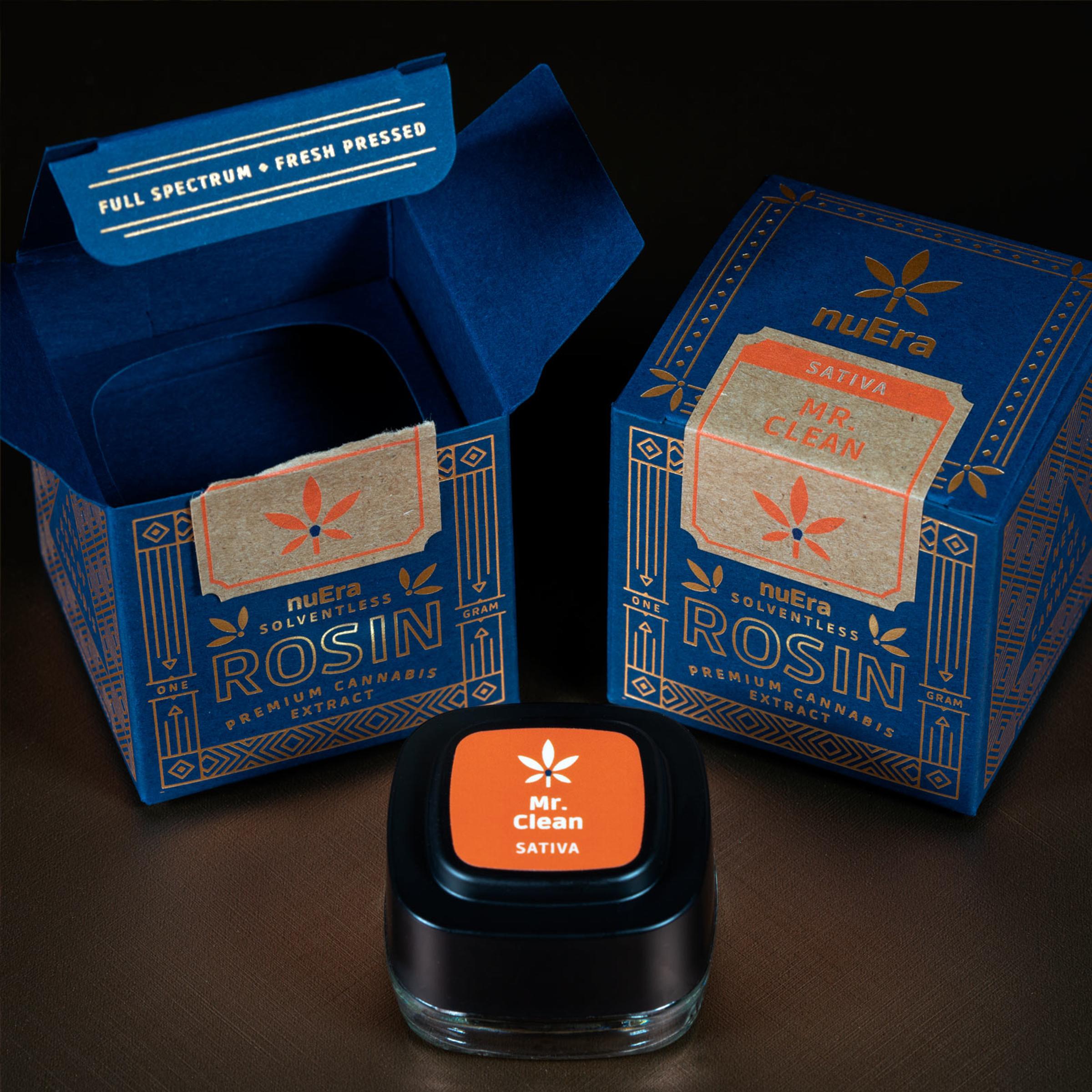 nuEra solventless rosin boxes in navy and gold with a Mr. Clean concentrate jar