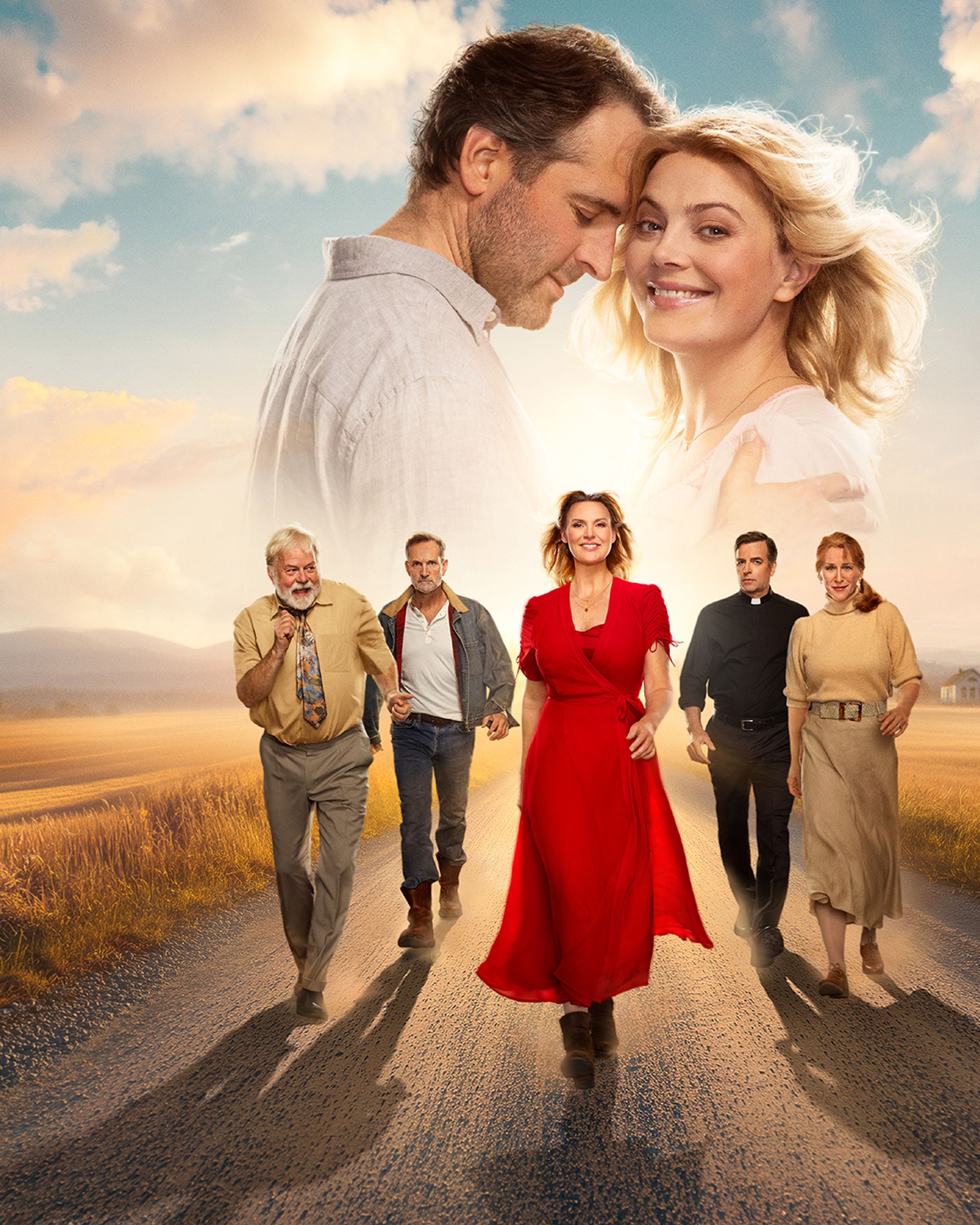 Så som i himmelen manér. Personer som går framåt i bild ledd av Sanna Nielsen på en landsväg med en äng. Ett par som ser lyckliga ut tillsammans syns längre upp i bild.