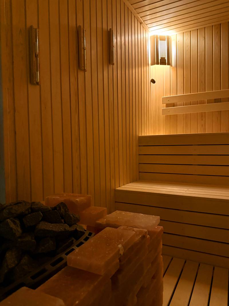 A sauna lined with Himalayan salt blocks and stones for steam
