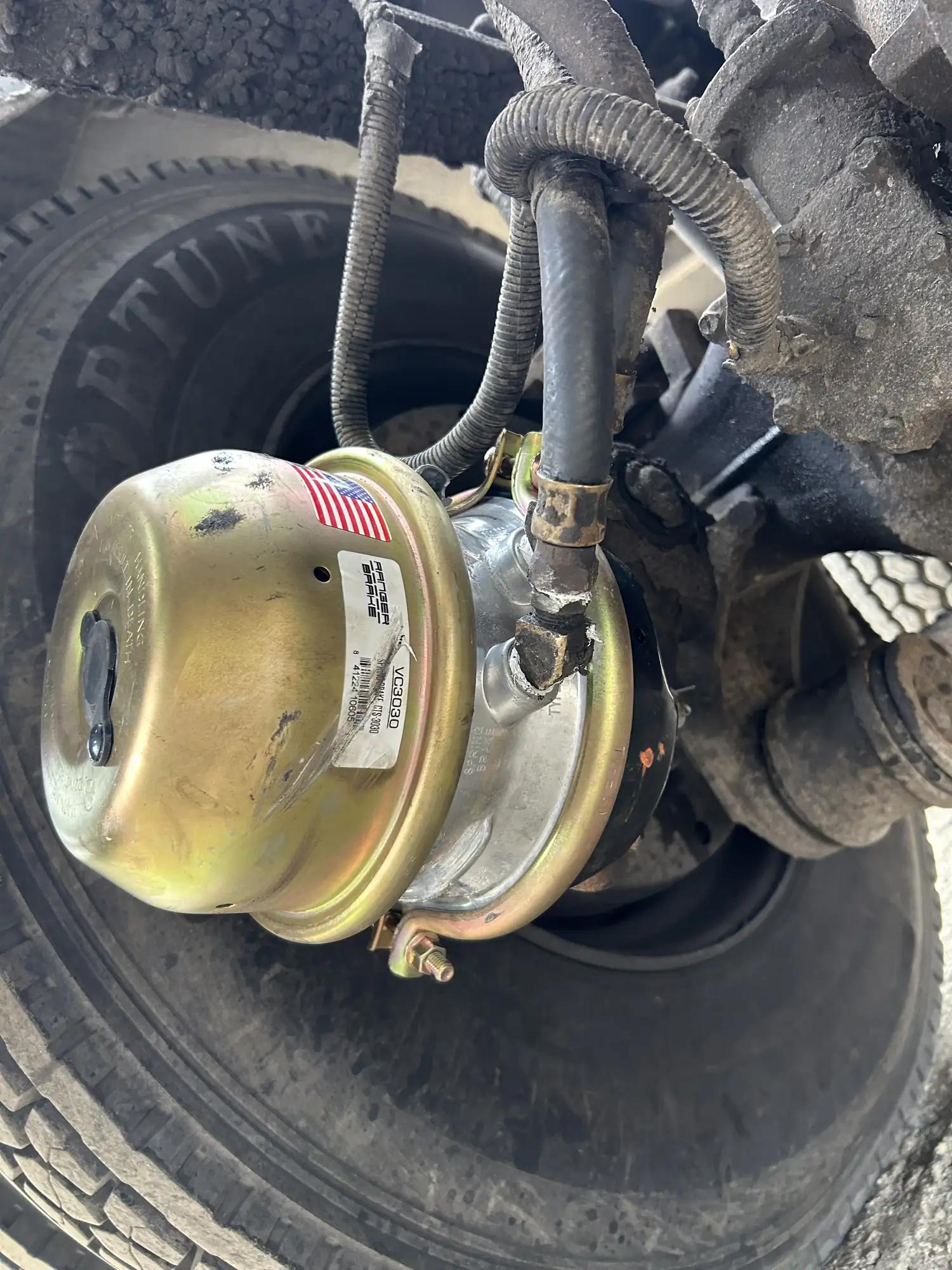 New brake chamber installed on a truck axle during air brake repair