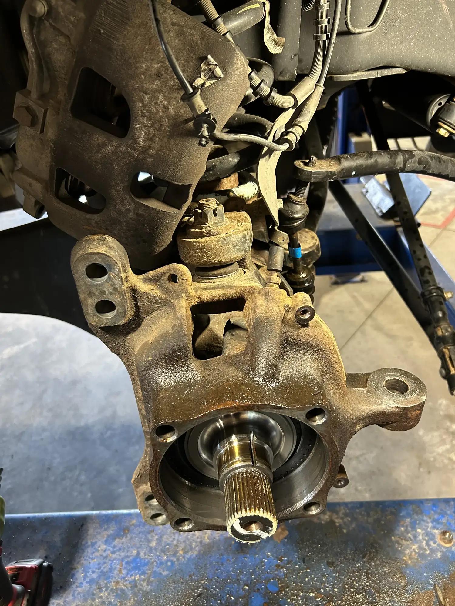 Truck steering knuckle and axle spindle during wheel-end repair