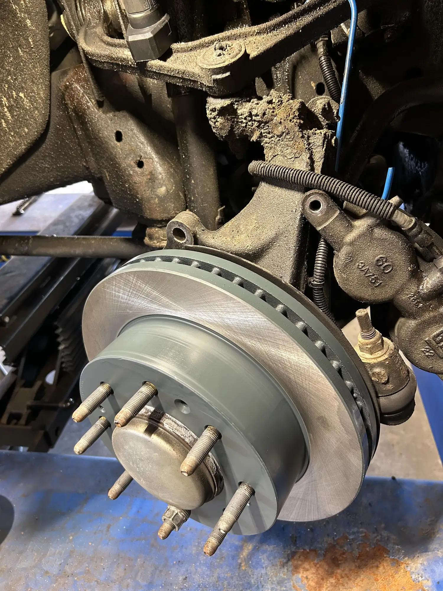 Truck brake rotor and hub exposed during a brake repair