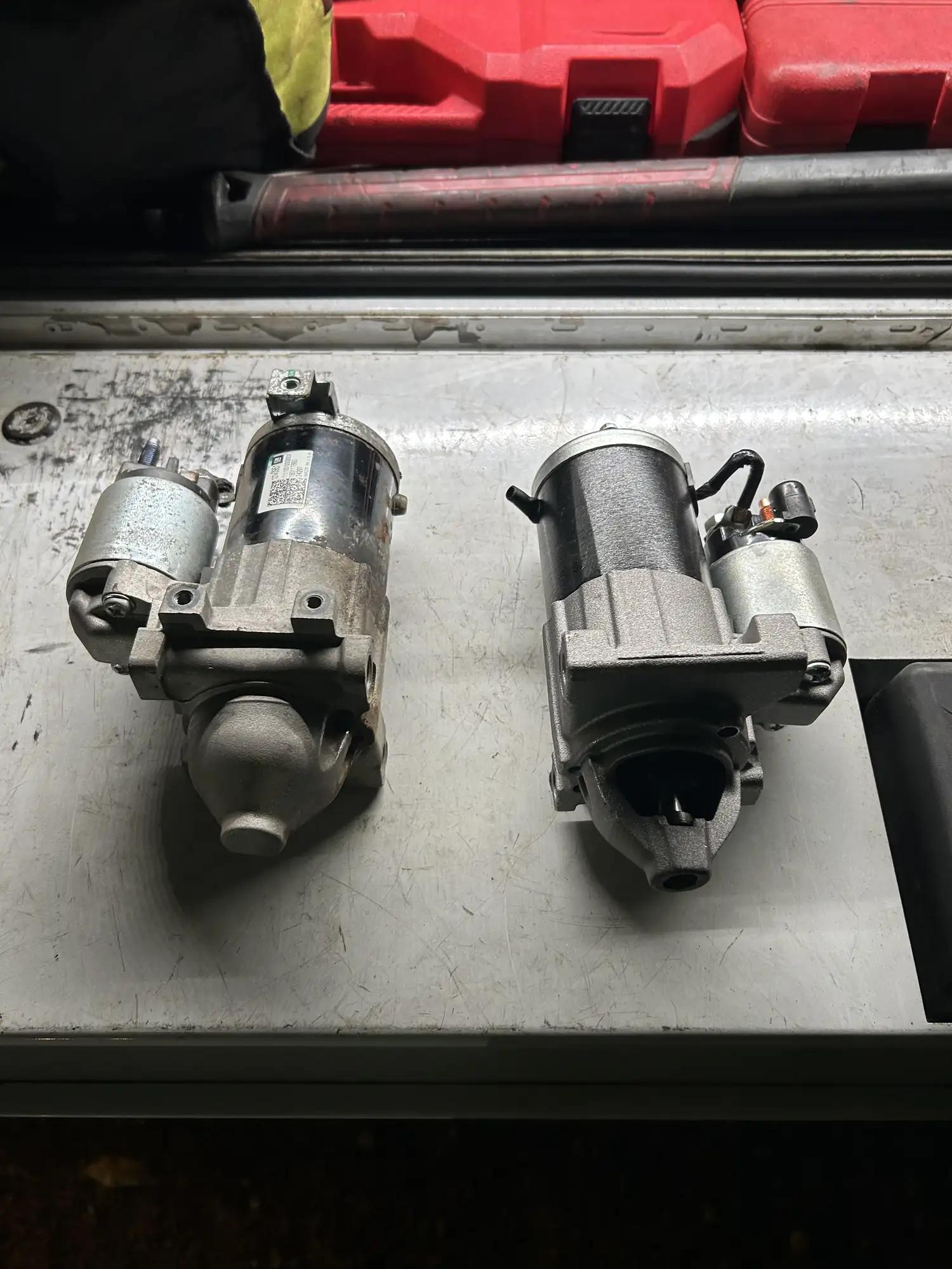 Old and new truck starter motors side by side before install