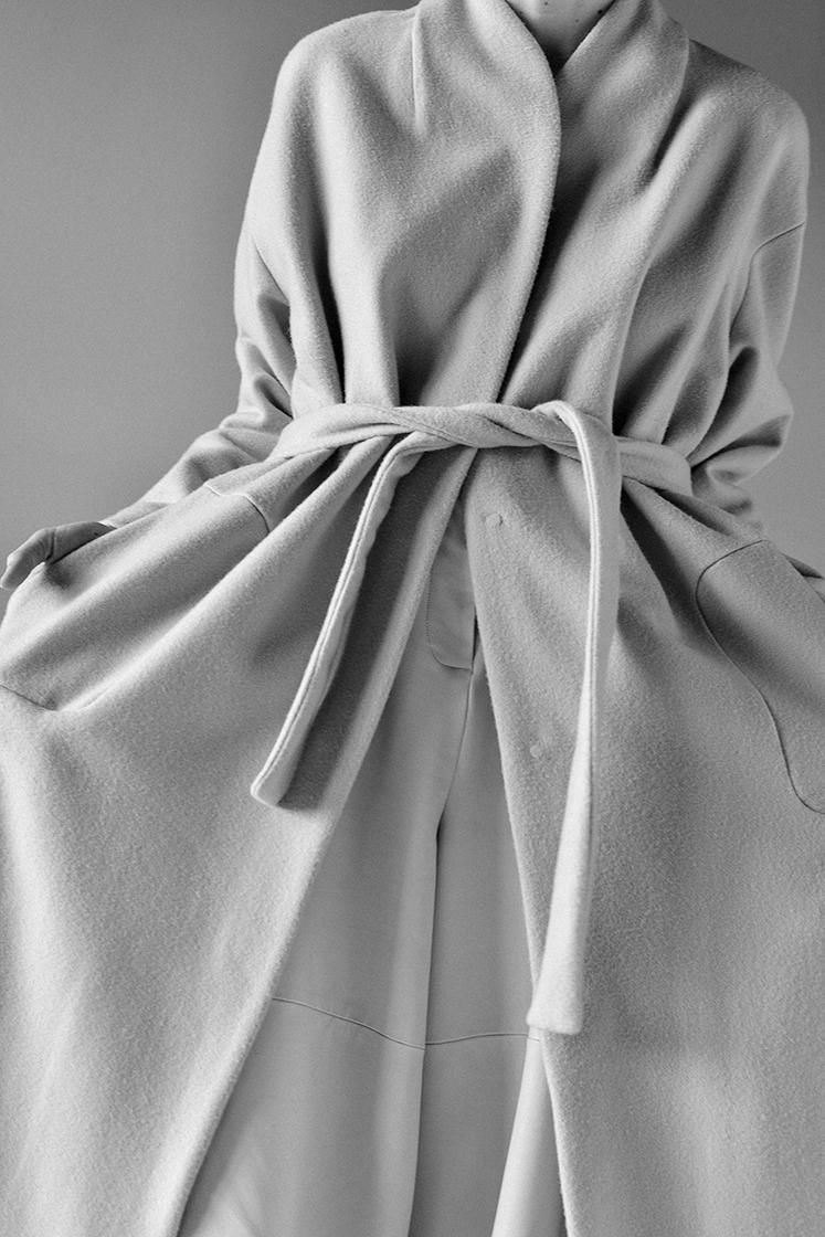 coat with belt detail view black and white