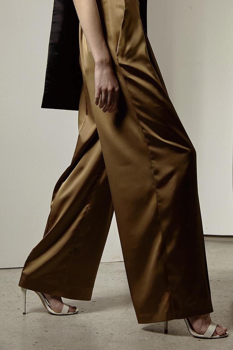 model in wide trousers taking big step