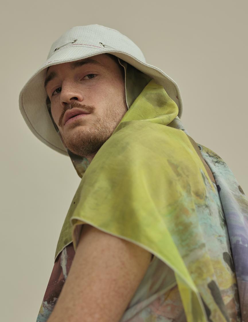 model wearing a hat and a scarf