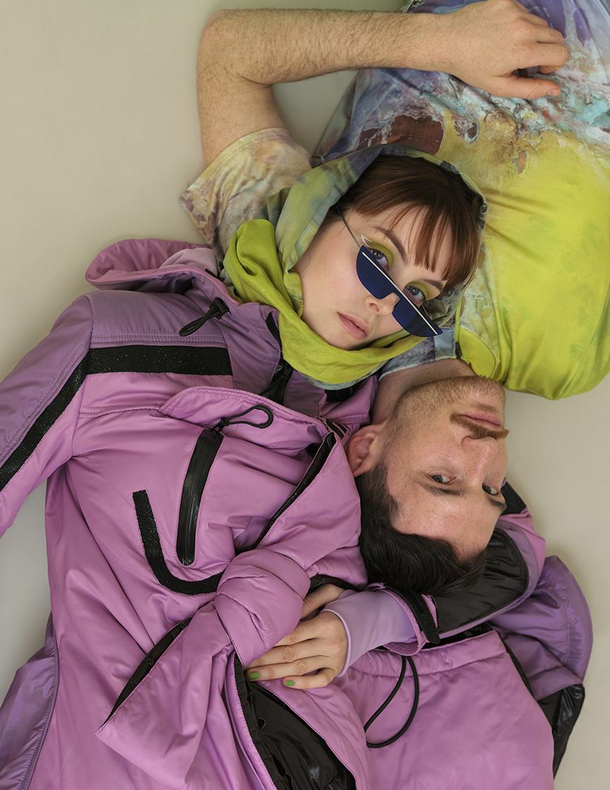 2 models laying on the floor looking up