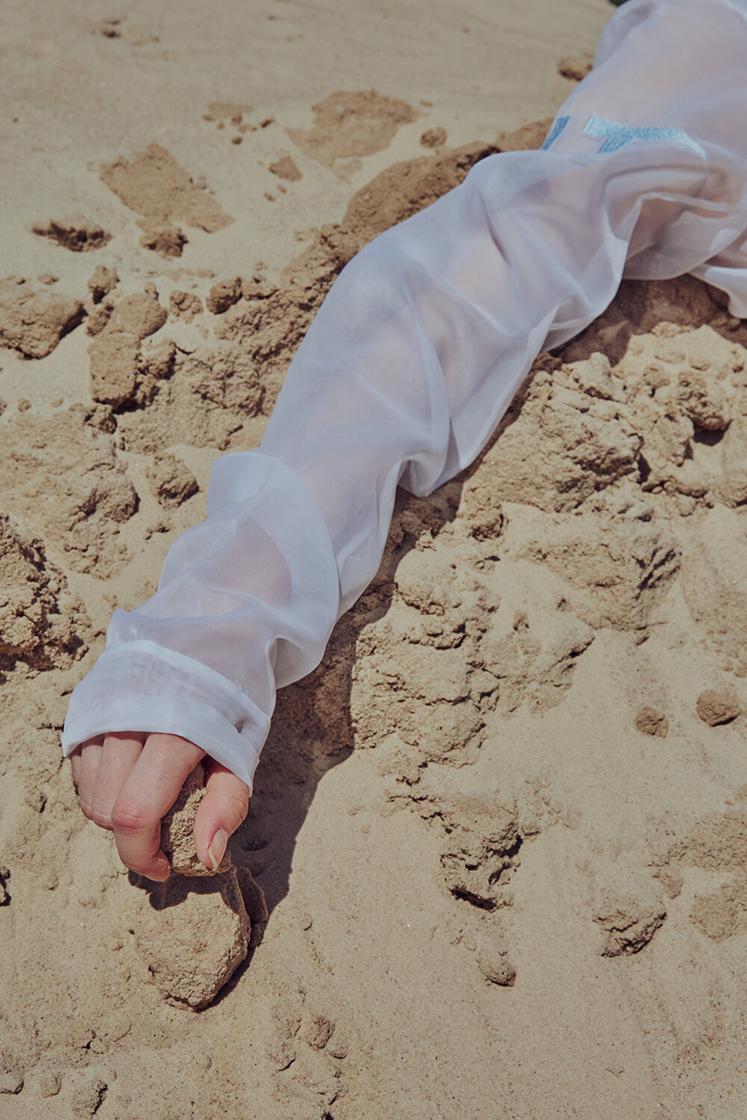 detail view of hand in the sand