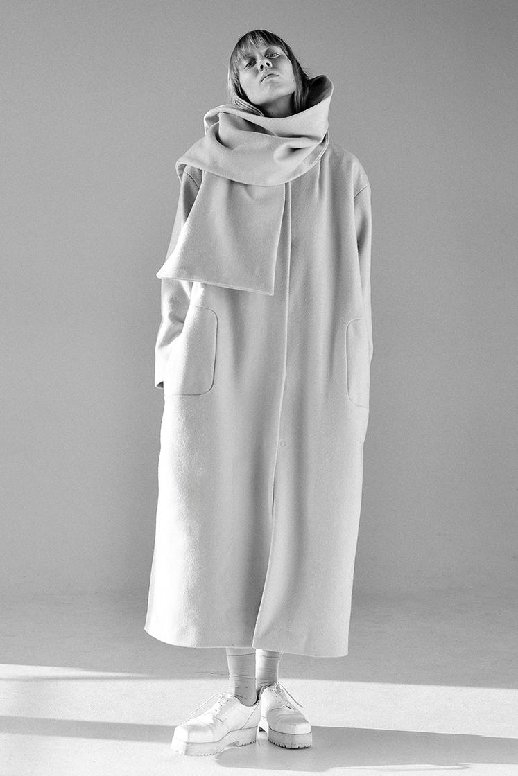 female model wrapped in scarf and coat black and white