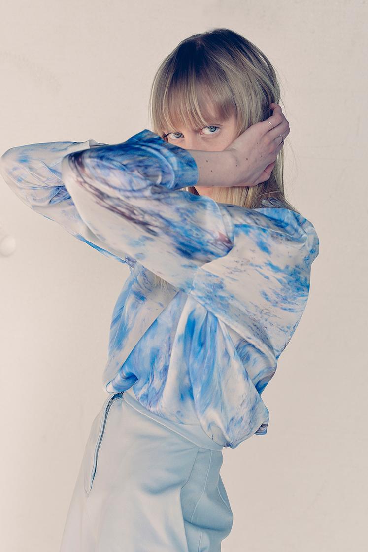 female model hiding her face with her arms