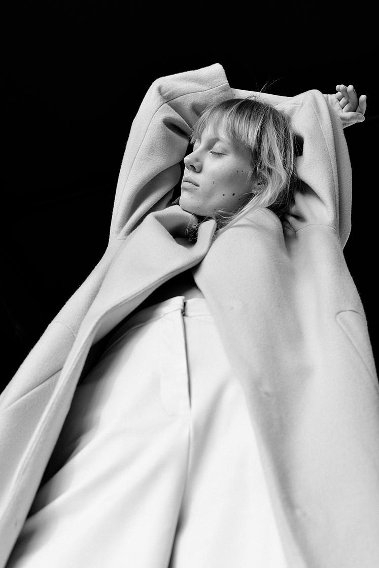 female model with arms above her head