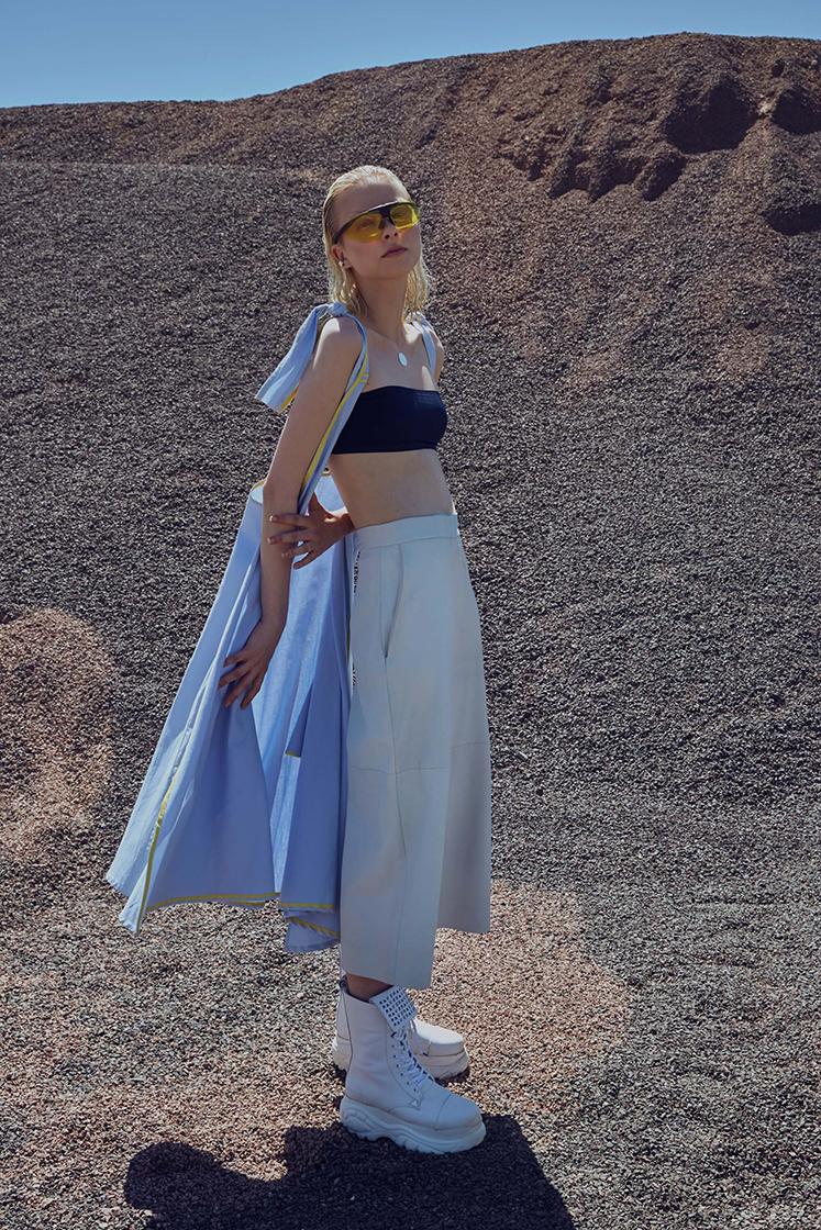female model standing in front of hill