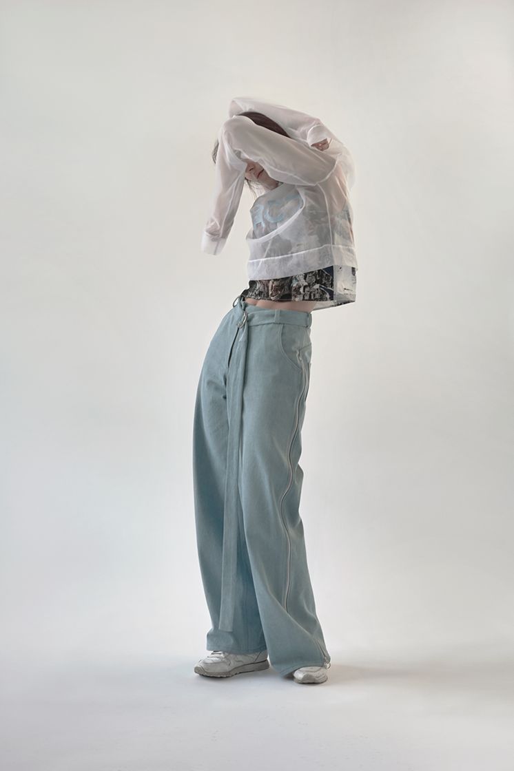 female model hiding head in front of arms