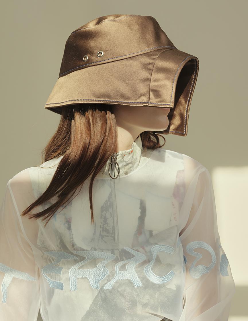 model from profile view with hat hiding the face