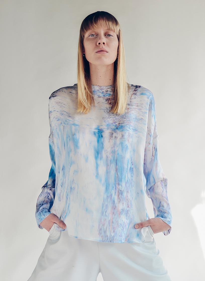 female model standing with her hands in pockets
