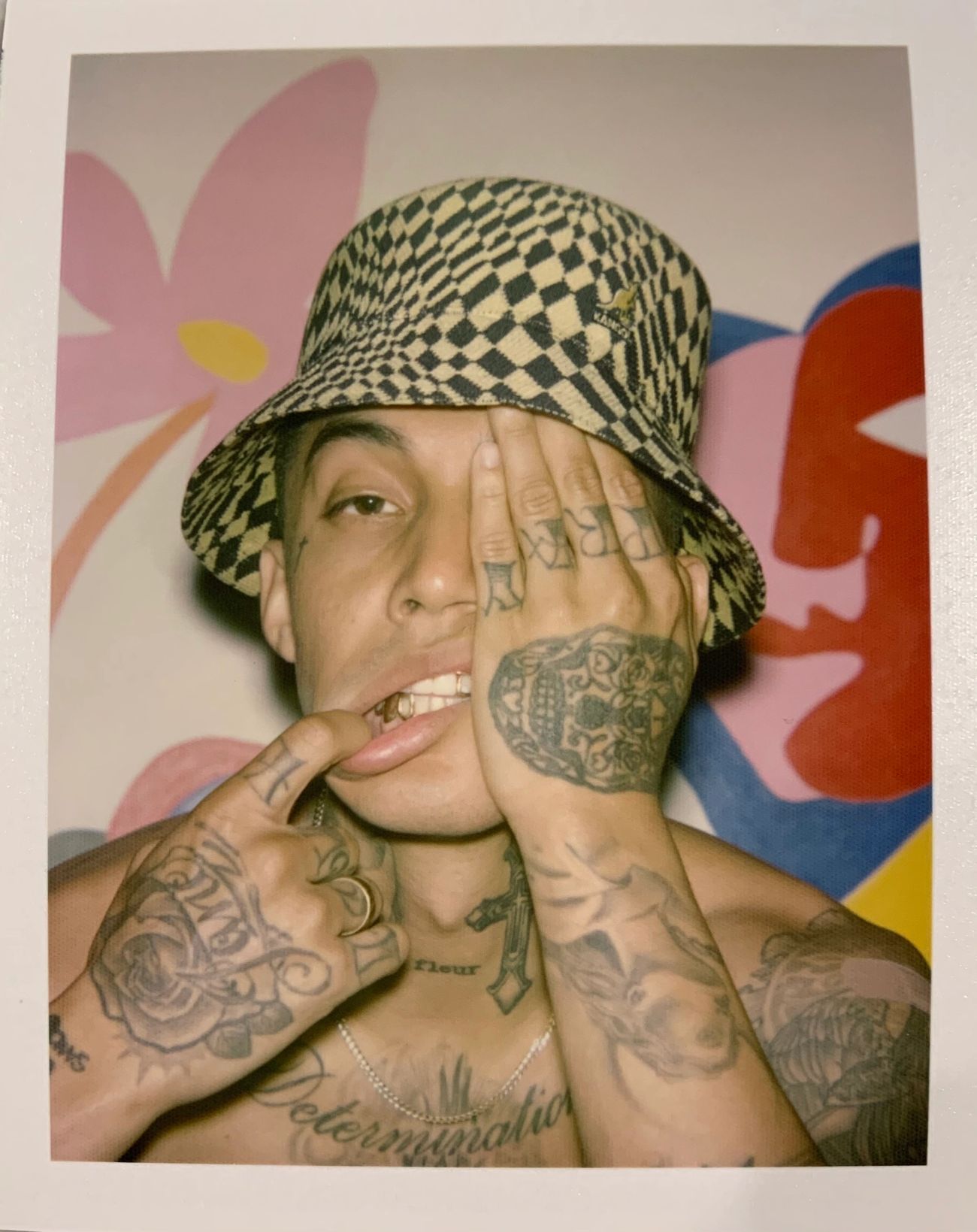 Polaroid of man with tattoos