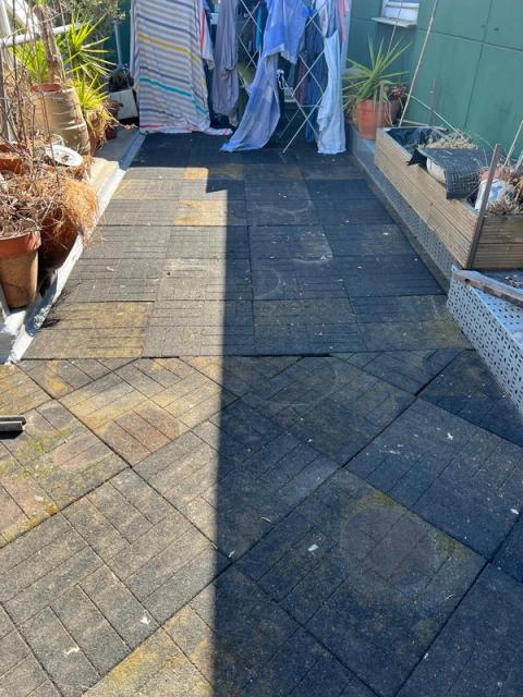 Terrace deck tiles covered in moss and dirt before waterproofing