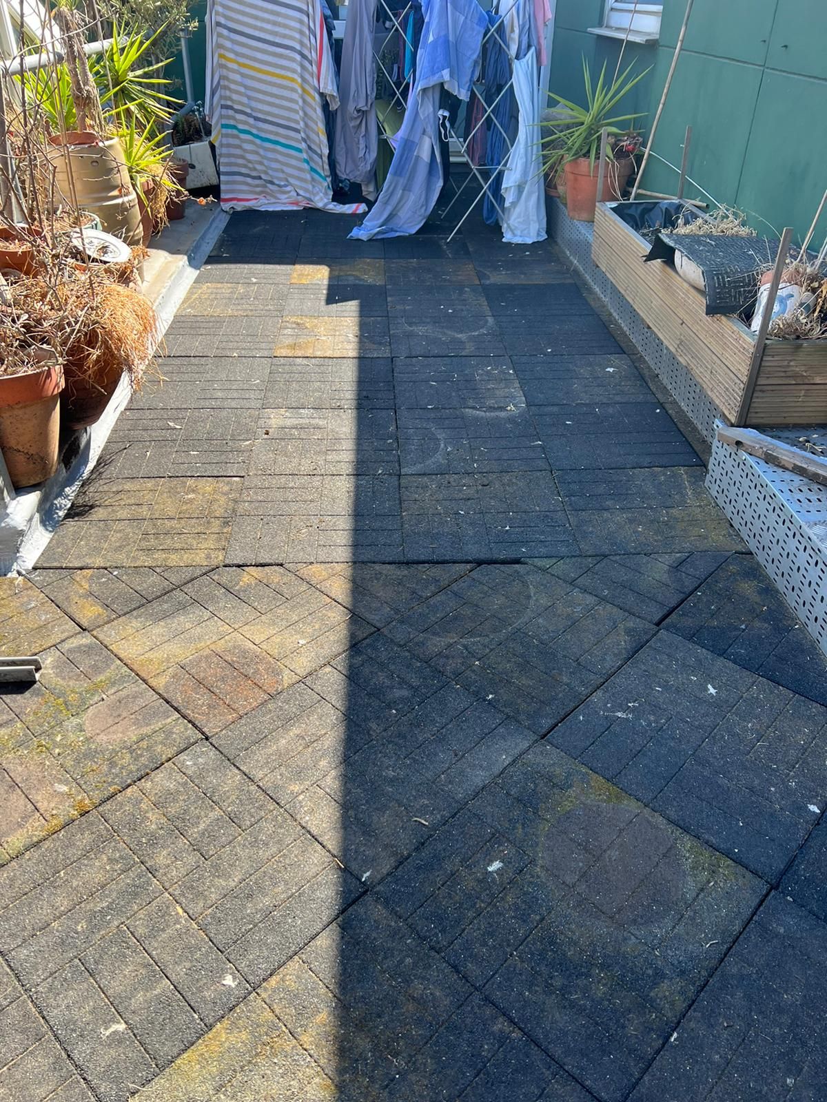 Terrace deck tiles covered in moss and dirt before waterproofing