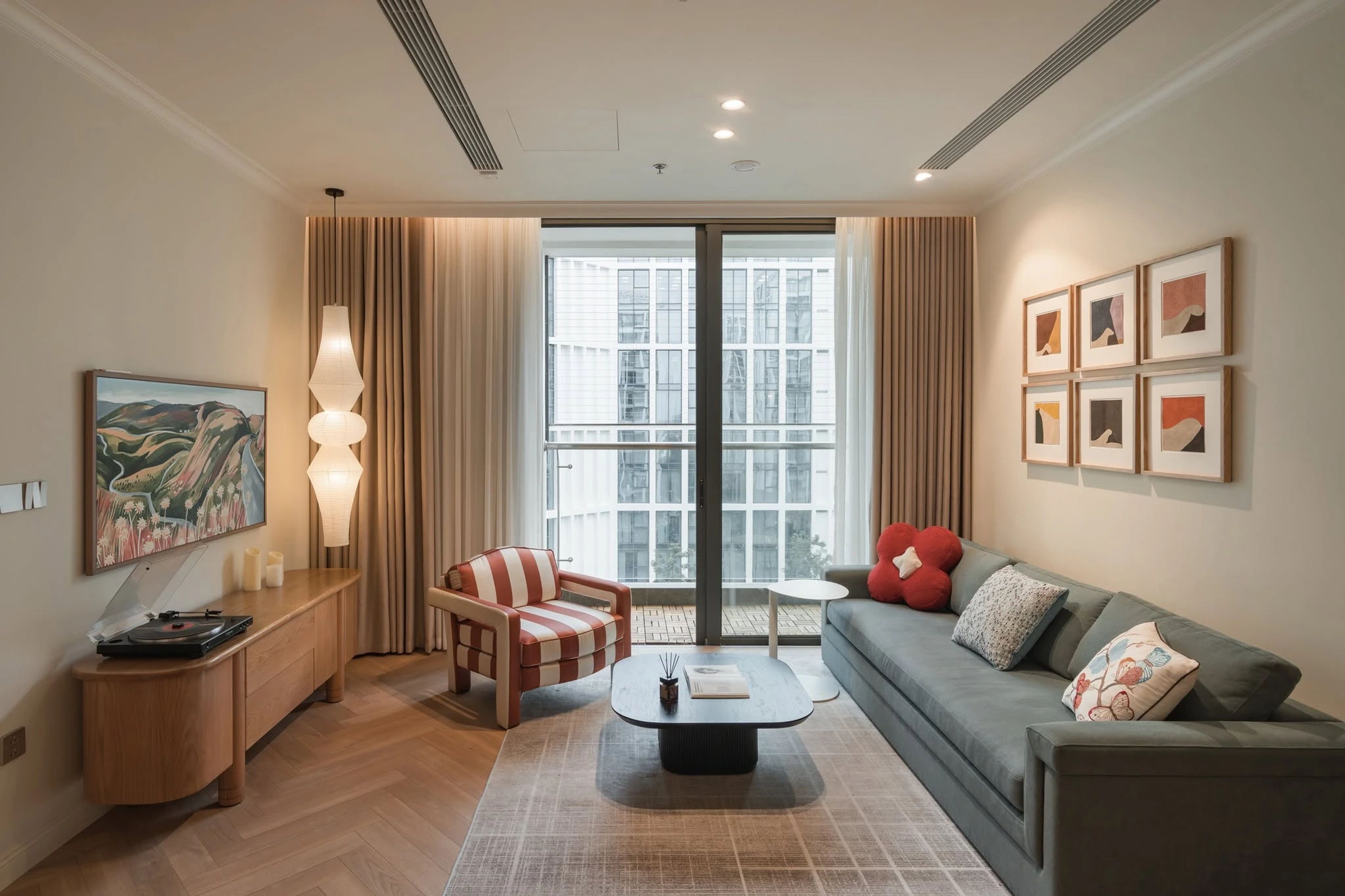 Living and dining room with herringbone oak floor and warm lighting