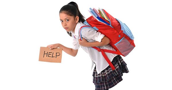 school girl carrying a heavy bag