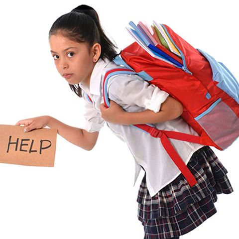 school girl carrying a heavy bag