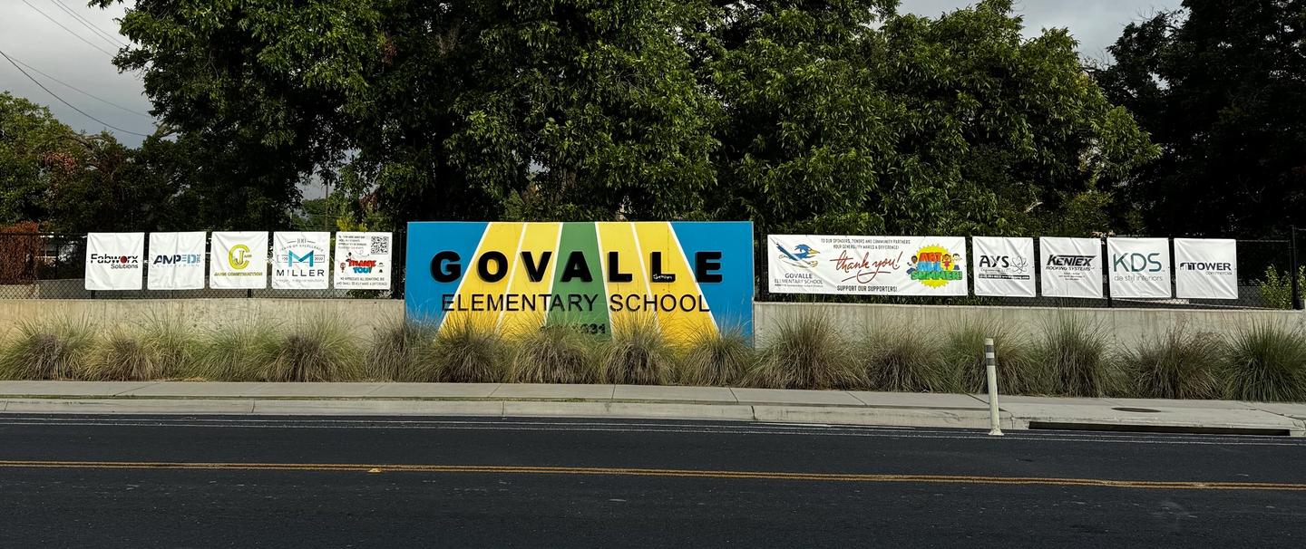 Photo of Govalle Sign and sponsor banners on Springdale Road