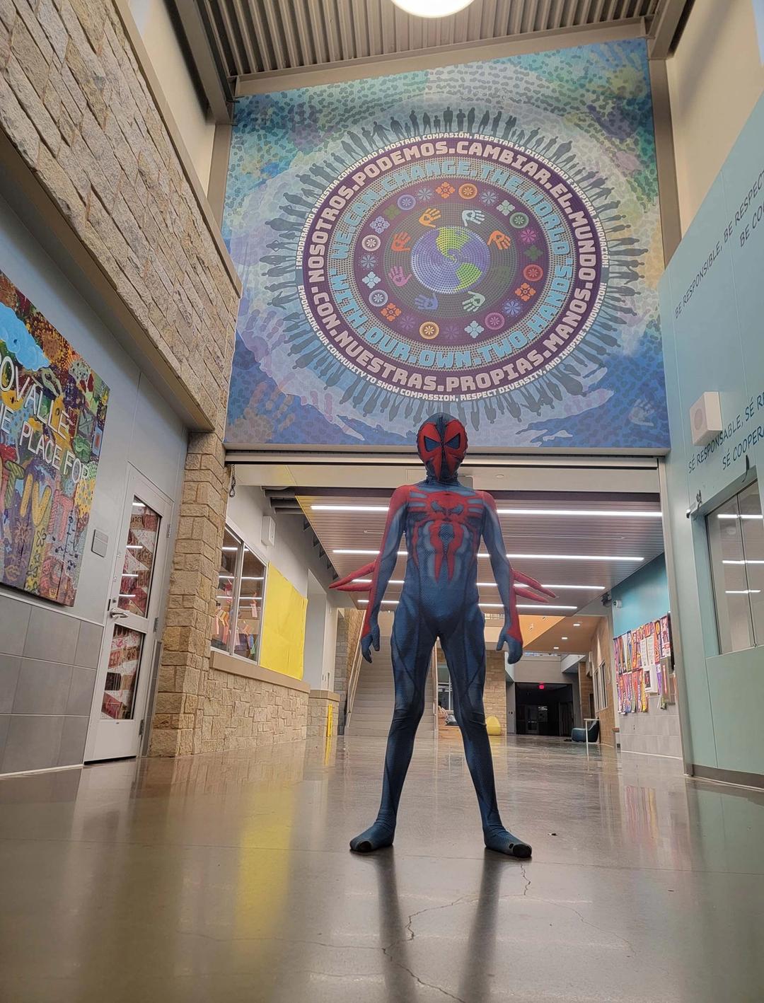 Spider man in front of hallway mural