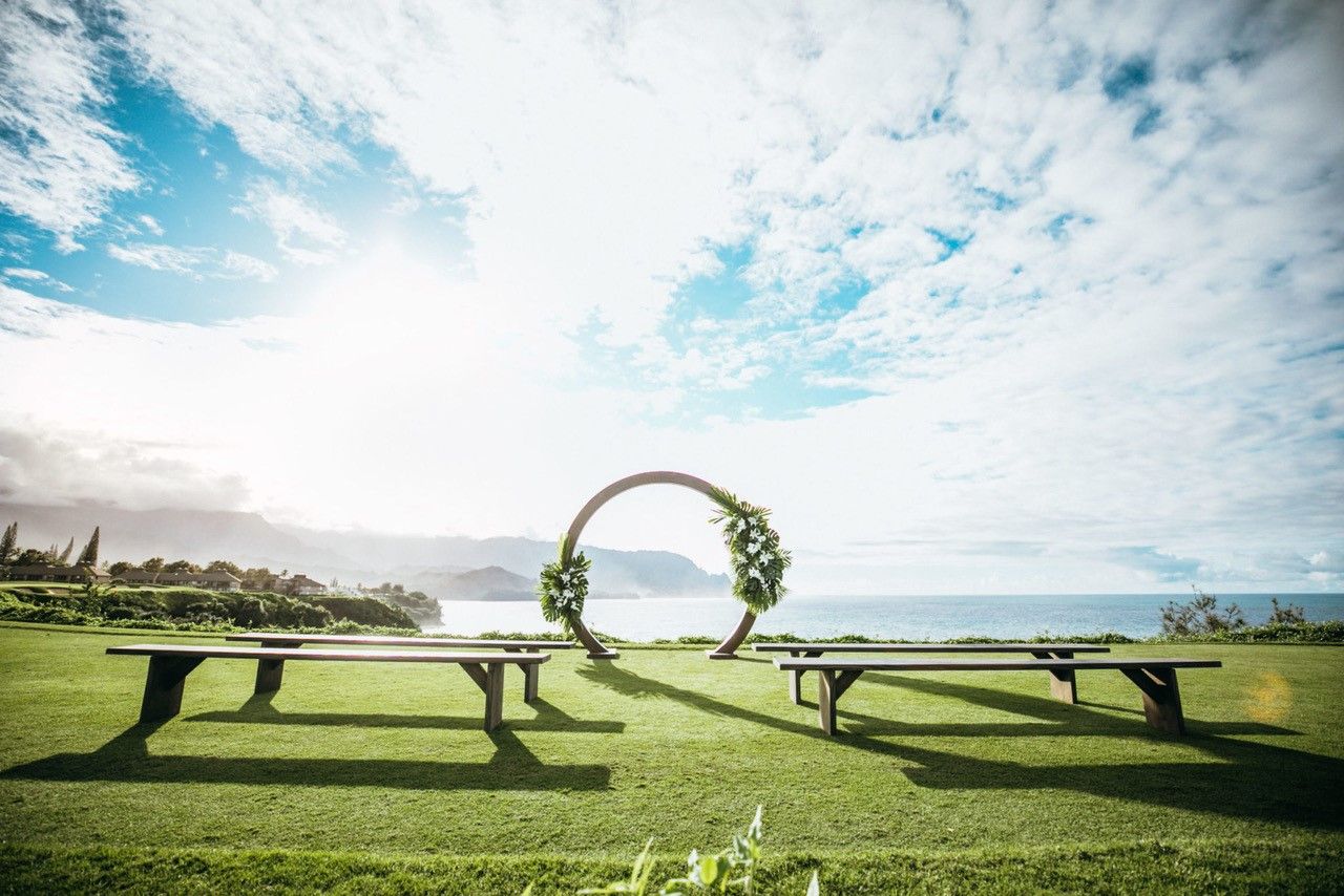Ceremony lawn with circular floral arch overlooking the ocean