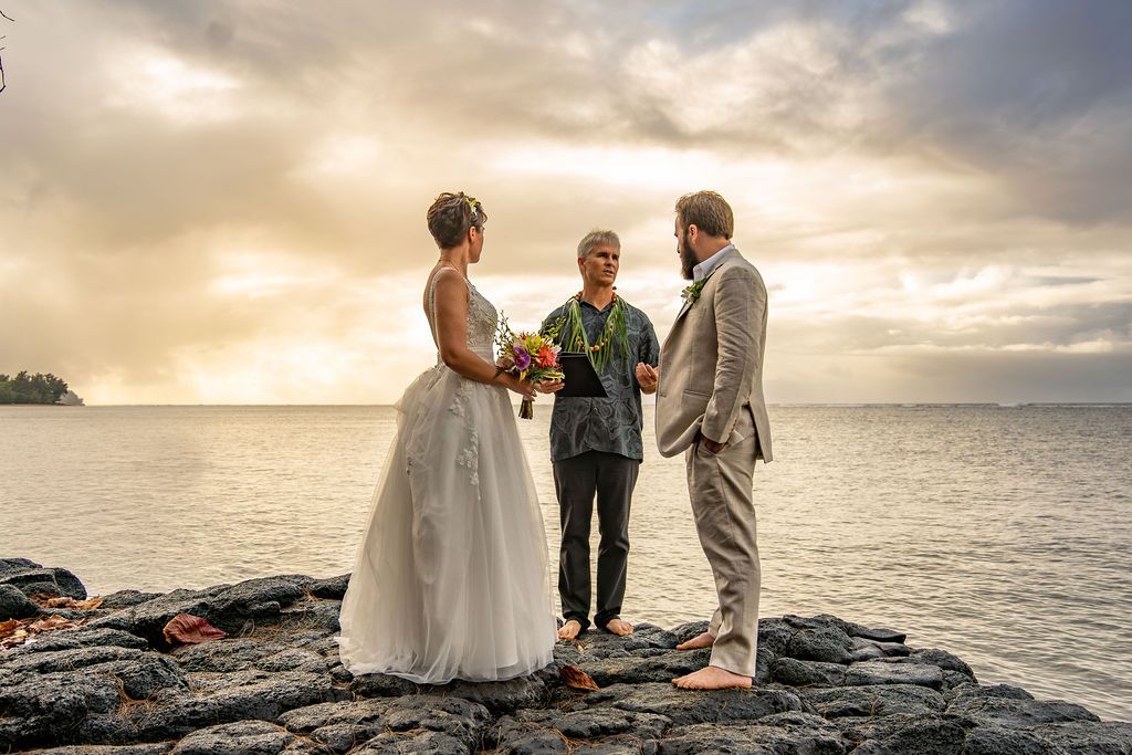 Intimate ceremony on Kauaʻi shoreline at golden hour