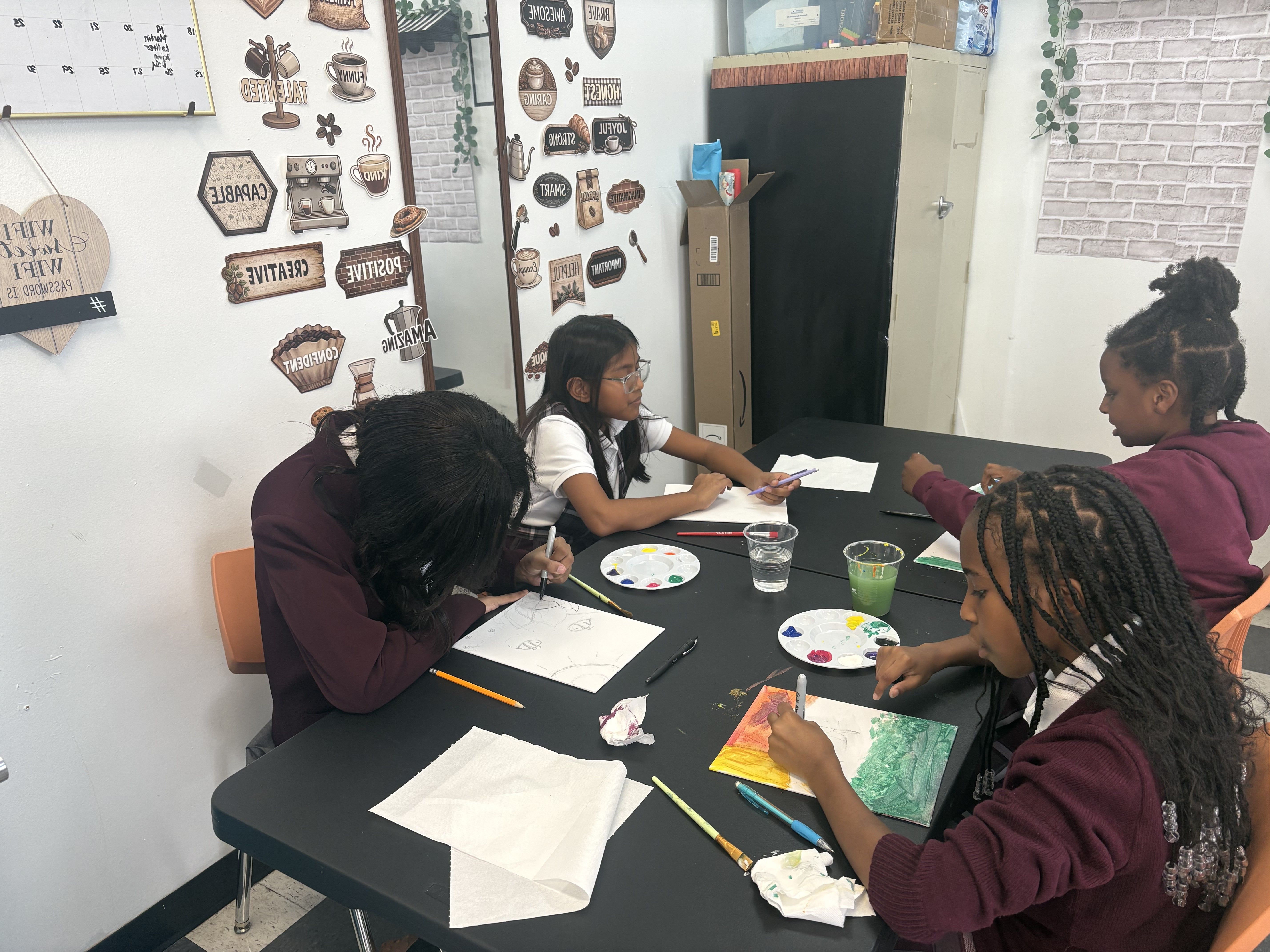 Children at the table learning, active working at the table.