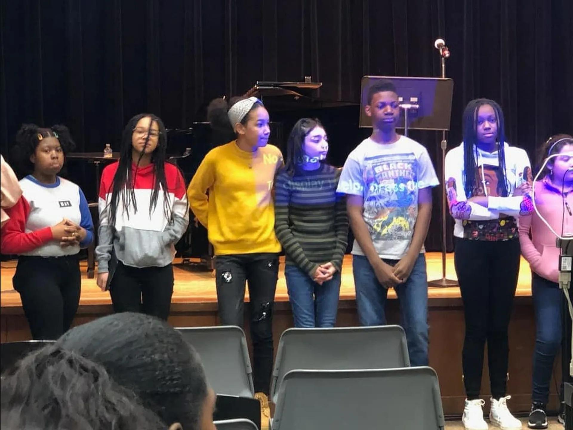 Students performing together on the school stage