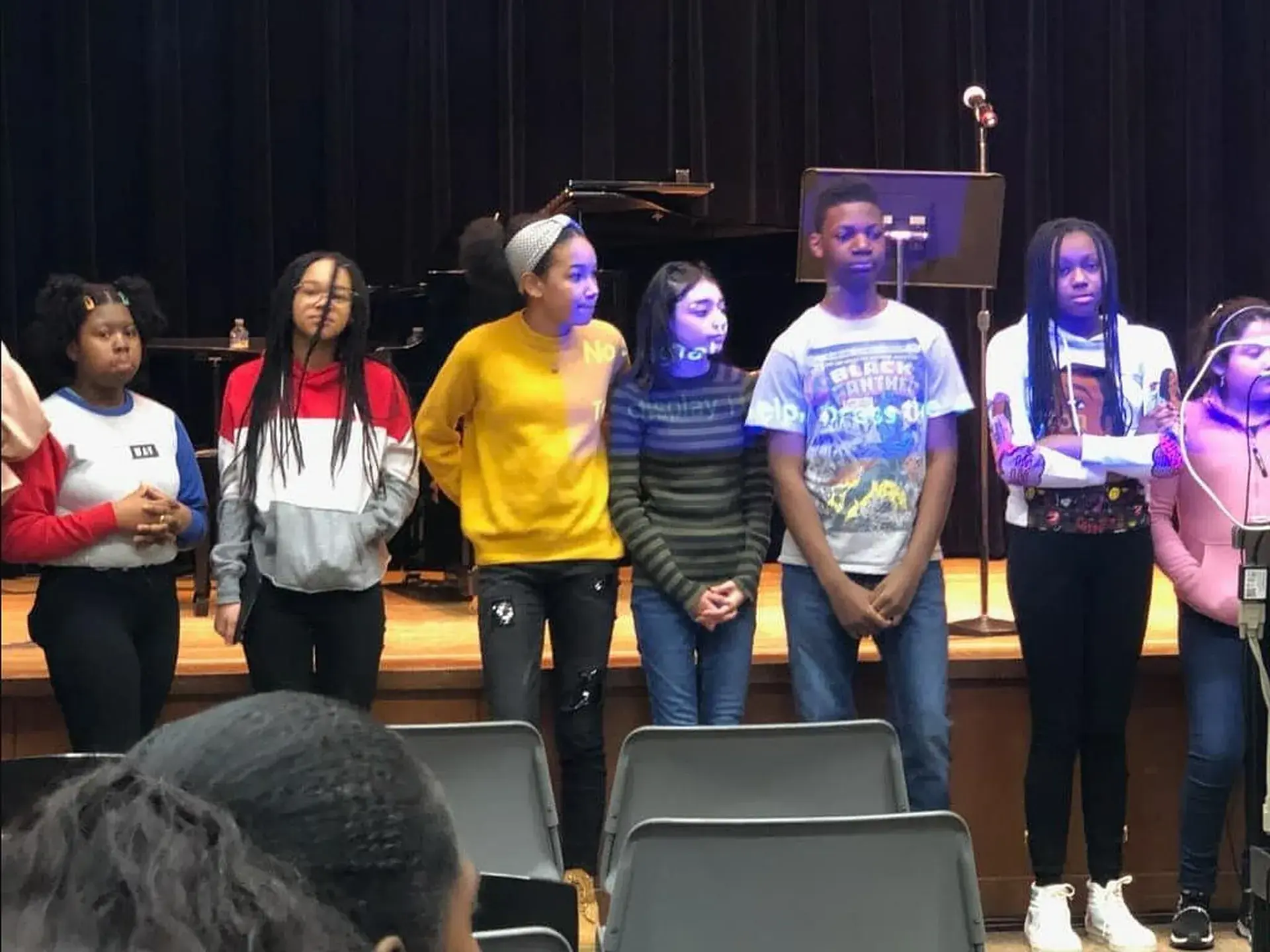 Students performing together on the school stage