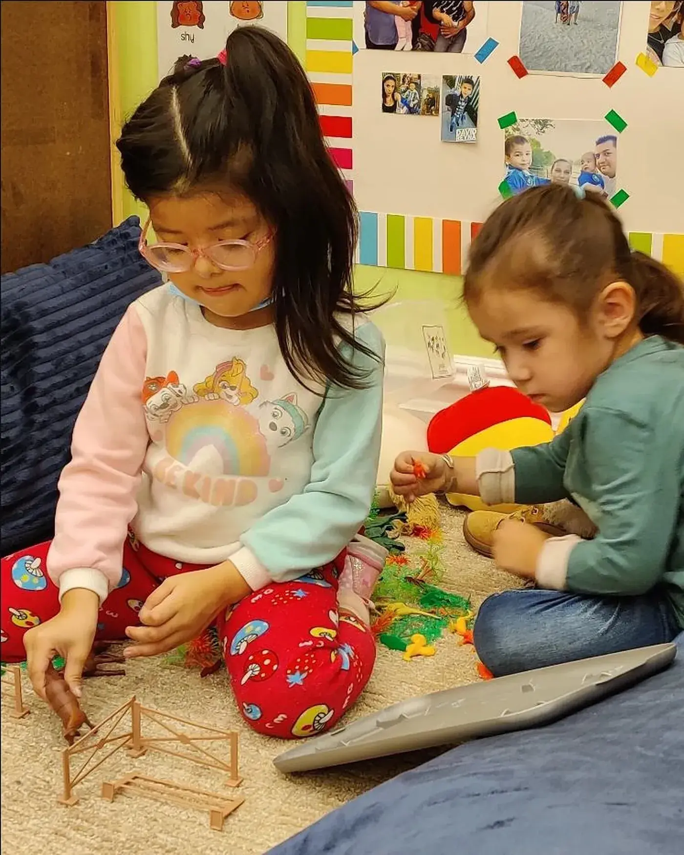 Young students at play together on the classroom floor