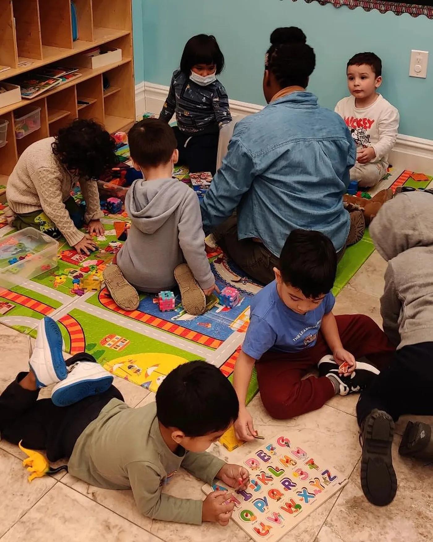 Young Learning Tree students at work together on the classroom floor