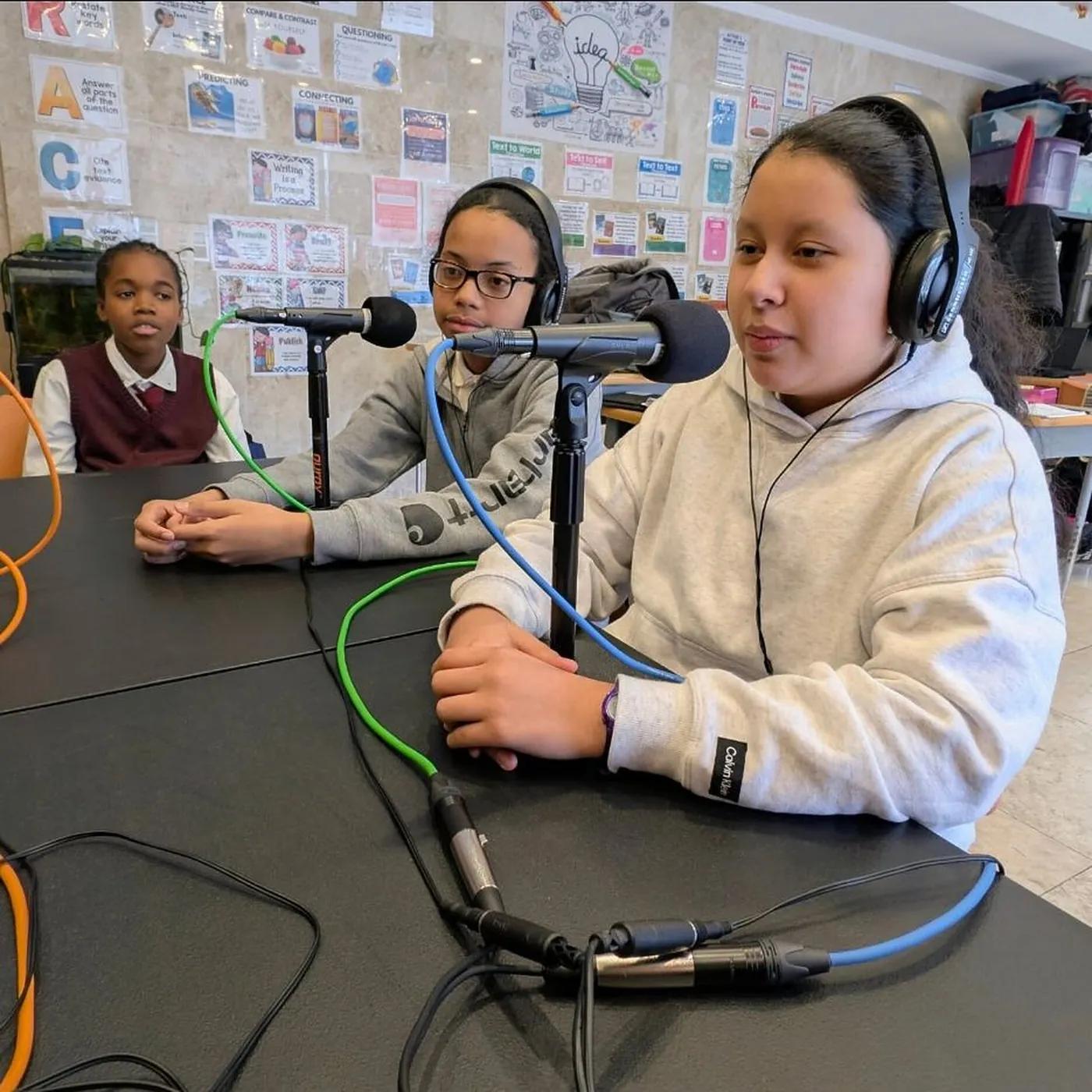 Two students recording at microphones in the Media Arts Lab