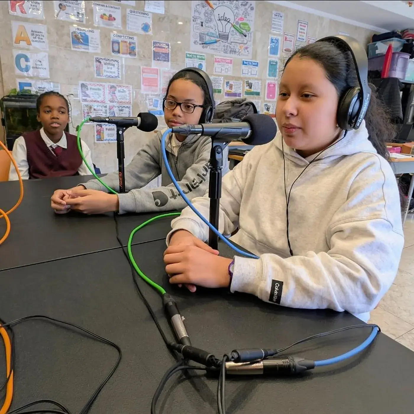 Two students recording at microphones in the Media Arts Lab