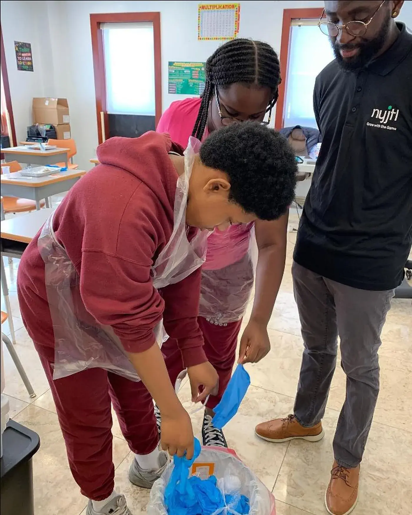 A teacher running an experiment with a group of students