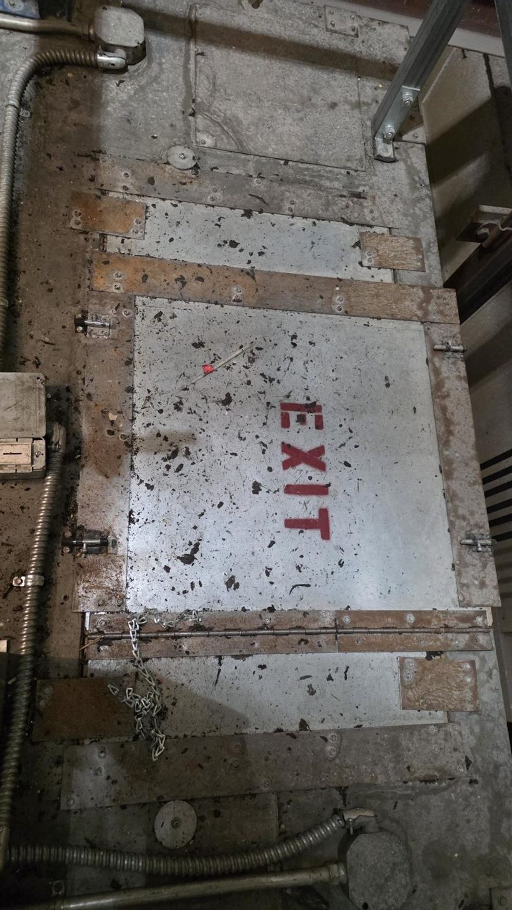 Top of an elevator car showing clumped dust around the exit hatch
