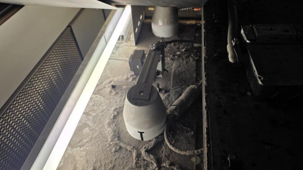 Equipment directly below the exit hatch covered in clumped dust