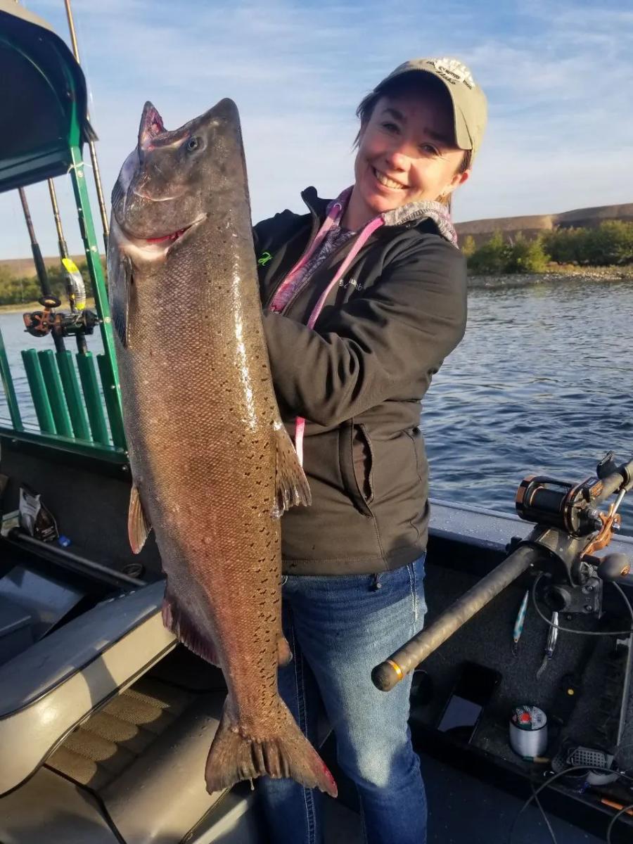 Woman holding a large salmon
