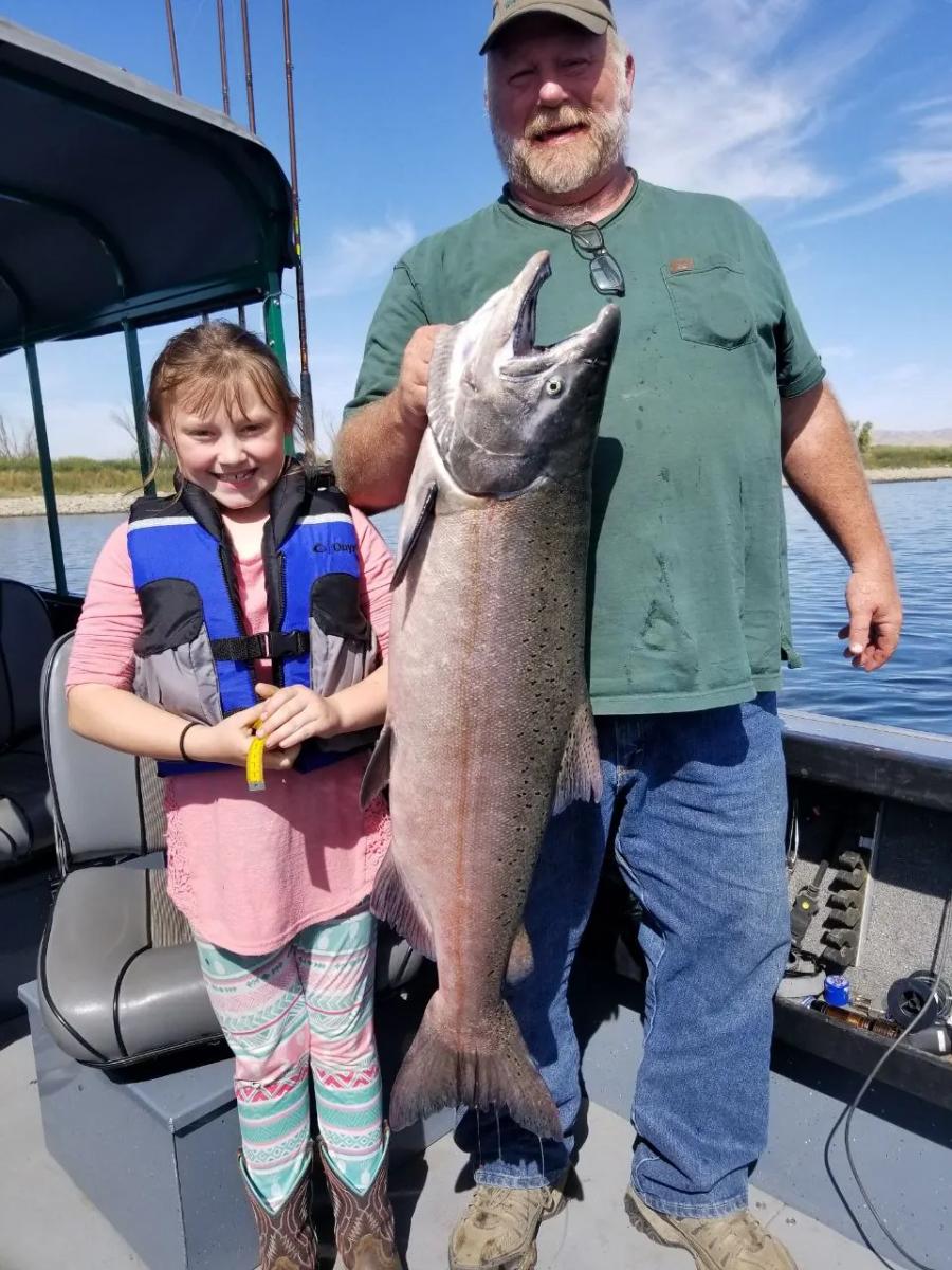 Family with a large salmon