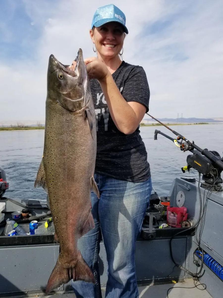 Woman holding a large salmon